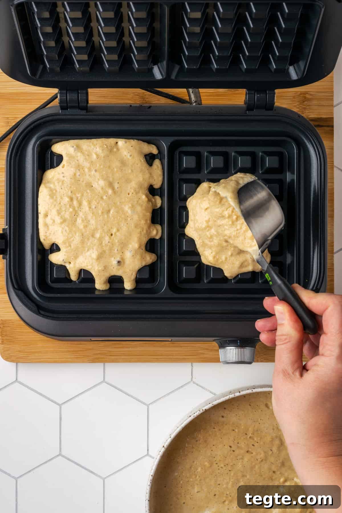 Crispy Oat Flour Waffles Recipe - Fluffy & Gluten-Free Option 15 Oat flour waffle batter being scooped into a hot waffle iron.