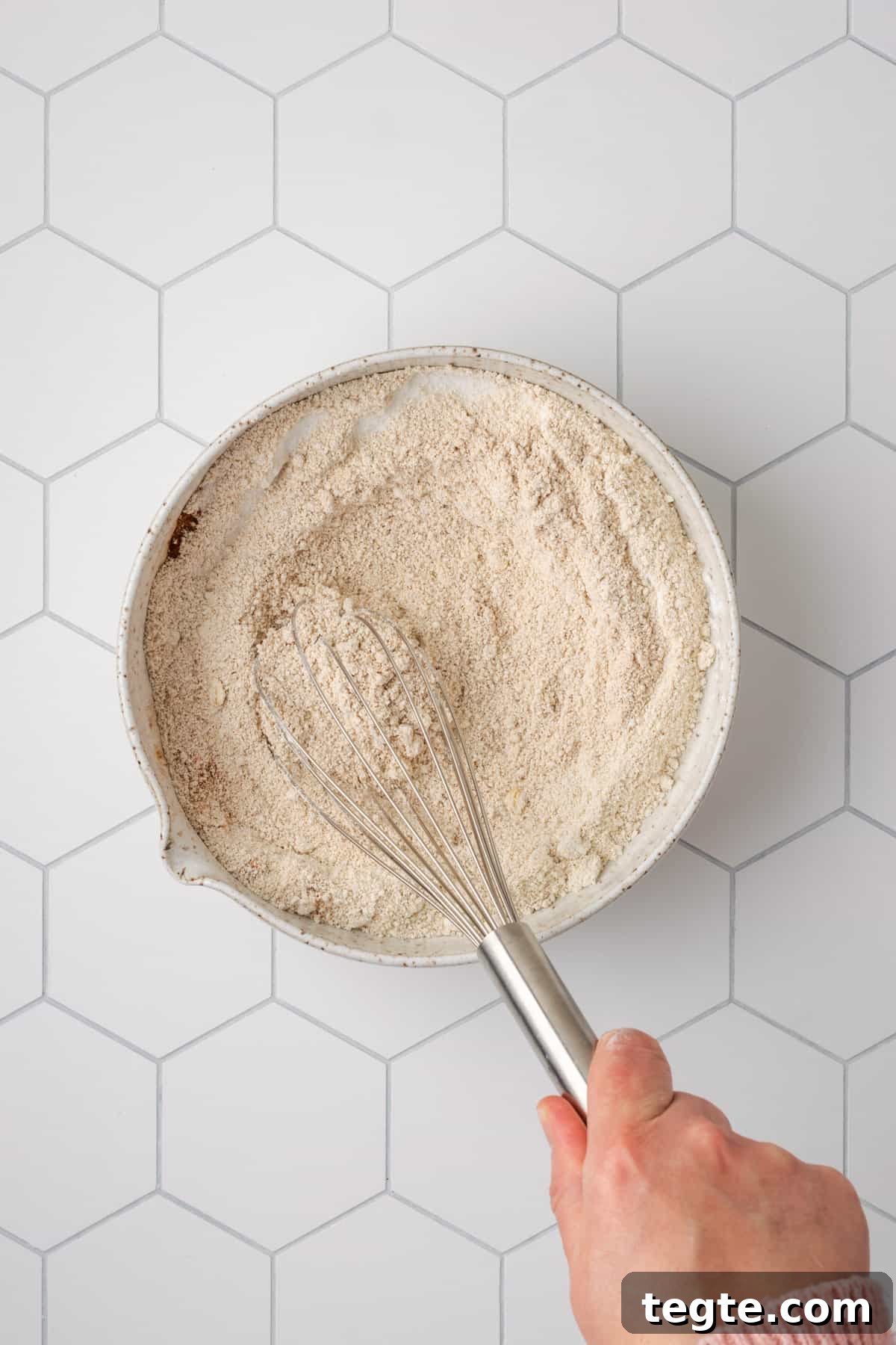 Crispy Oat Flour Waffles Recipe - Fluffy & Gluten-Free Option 7 Oat flour, baking powder, salt, cinnamon and sugar being whisked together in a large white bowl.