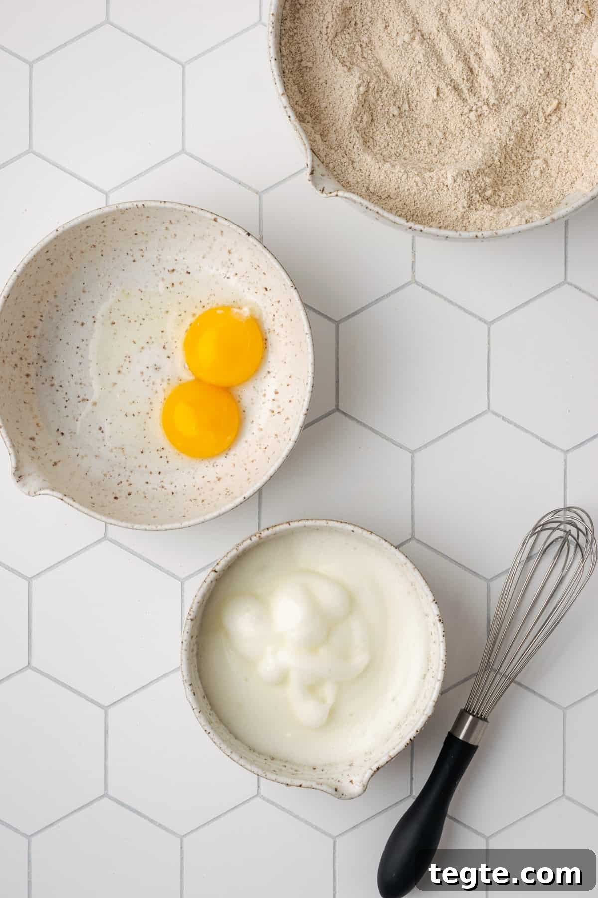 Crispy Oat Flour Waffles Recipe - Fluffy & Gluten-Free Option 9 Egg whites whisked to soft peaks in a small white bowl.
