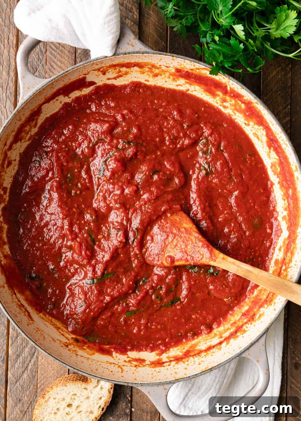 Homemade Marinara Sauce for Spaghetti (Meatless) 6 overhead: cooking spaghetti sauce in a large skillet with a wooden spoon visible
