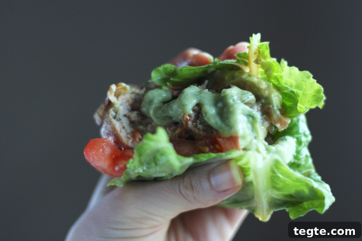 Stuffed Bacon Turkey Burgers - a glorious pairing of ground turkey and uncured bacon, stuffed with cheese, and topped with caramelized onions and avocado ranch dressing! GF, Paleo, DF. | fedandfulfilled.com