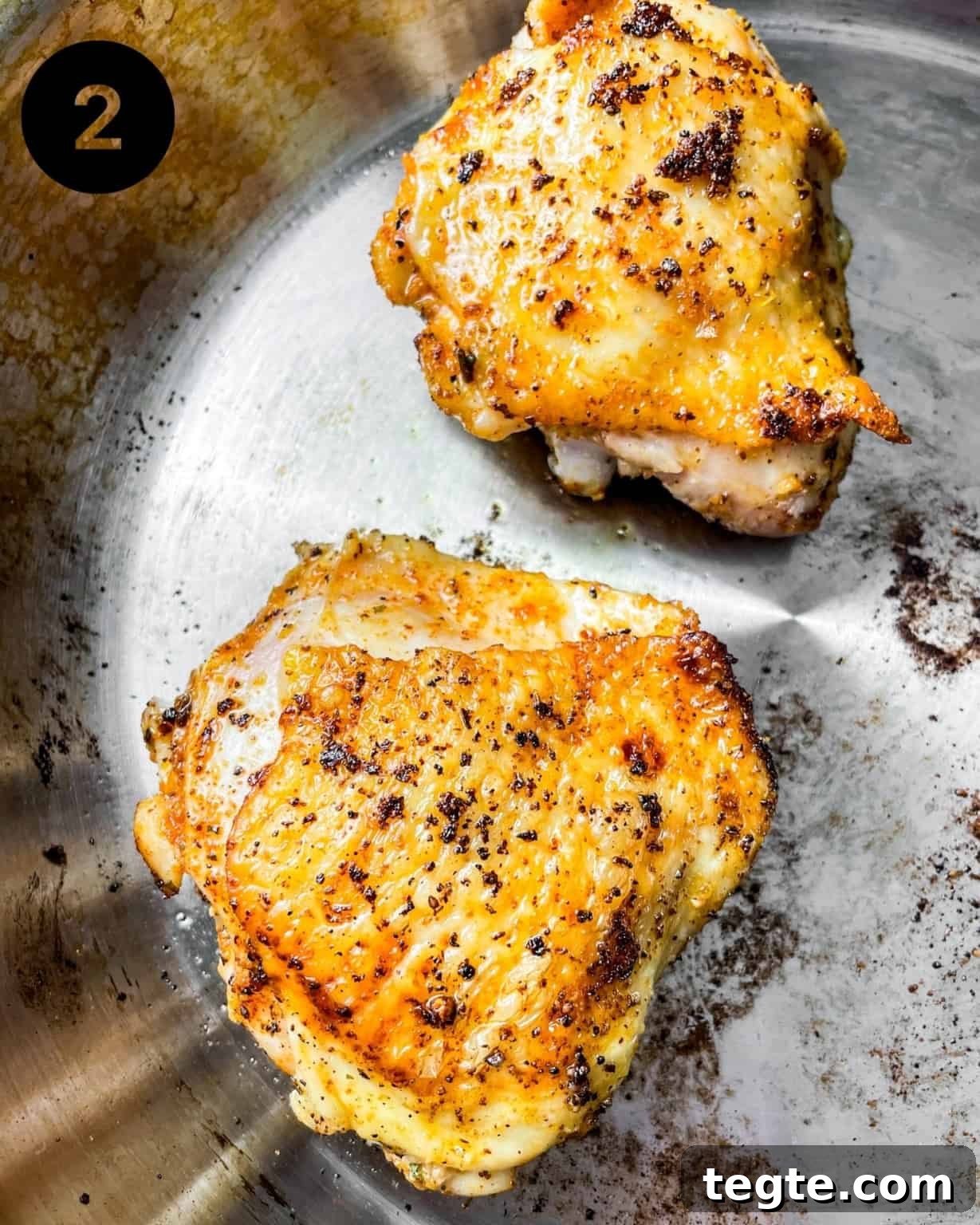 Oven-Baked BBQ Chicken Thighs with Crispy Skin and Sticky Glaze 5 seared chicken in a pan.