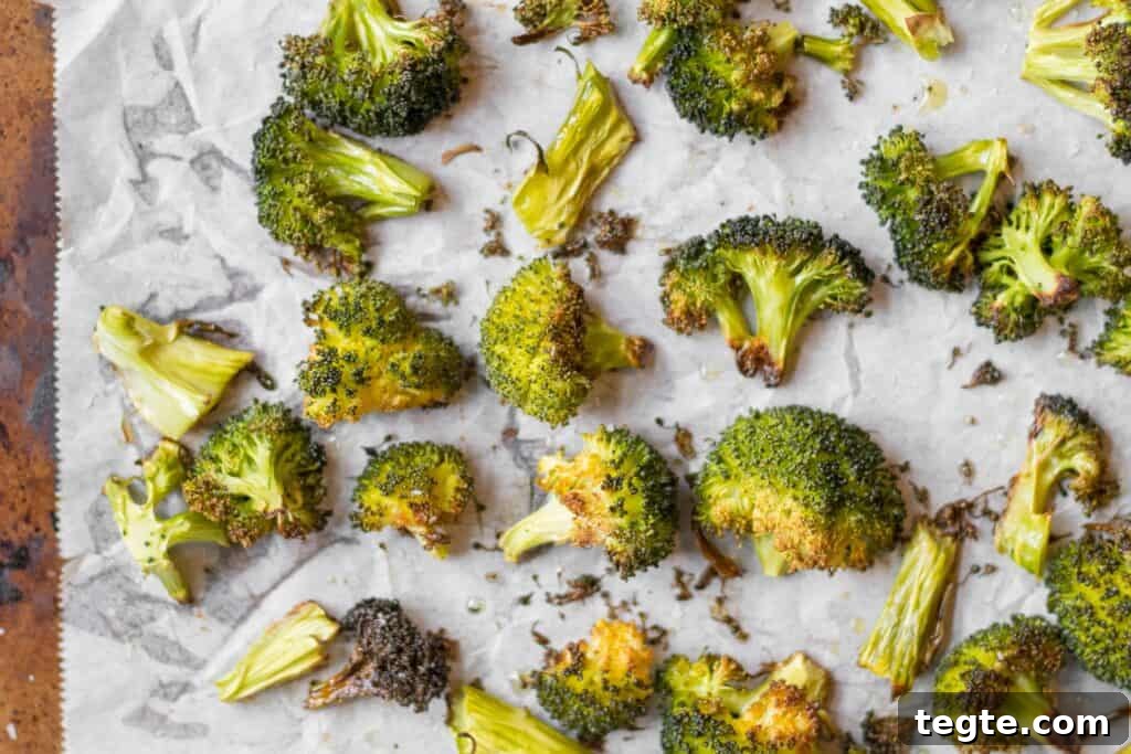 Roasted Broccoli Guide: Crispy Oven Recipe for Perfect Results 2 roasted broccoli on parchment paper lined sheet pan