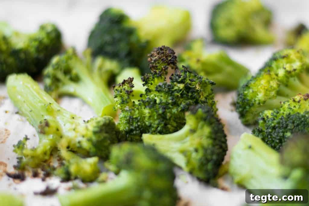 Roasted Broccoli Guide: Crispy Oven Recipe for Perfect Results 7 crispy roasted broccoli on a parchment lined sheet pan