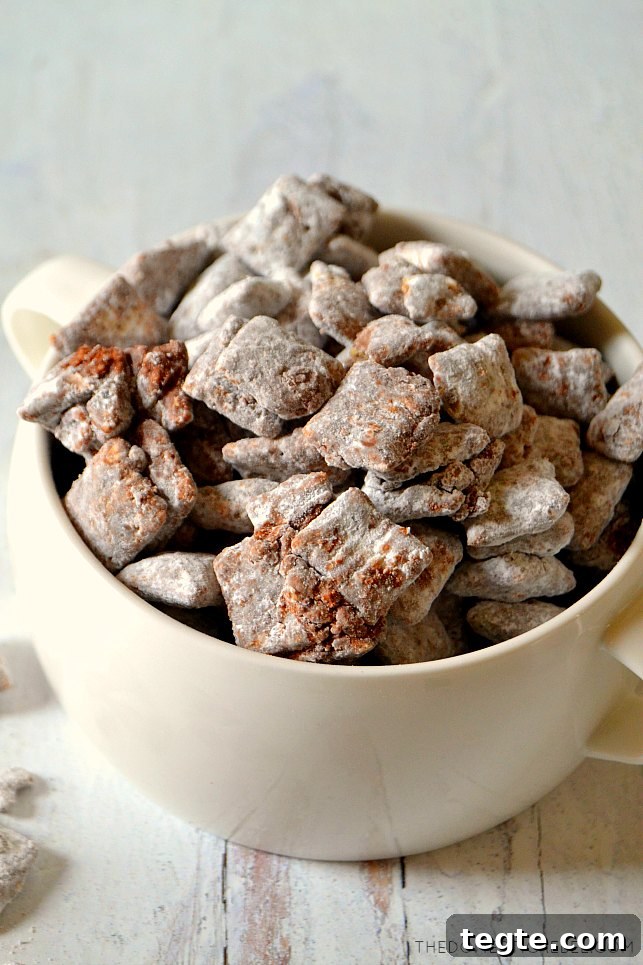 Ultimate Muddy Buddies Recipe — Perfect Chocolate-Peanut Rice Cereal Snack 6 White bowl of muddy buddies on white wood
