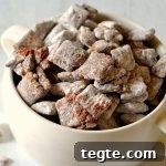 Ultimate Muddy Buddies Recipe — Perfect Chocolate-Peanut Rice Cereal Snack 7 white bowl of muddy buddies on white wood