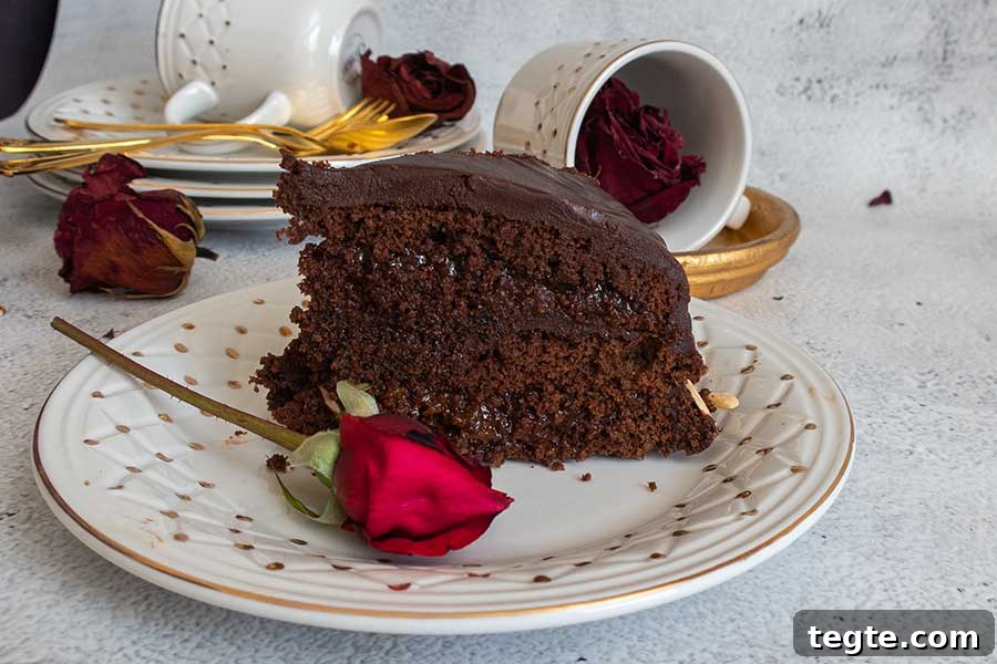 30 Gluten-Free Easter Desserts Your Guests Will Crave 16 a slice of sacher torte on a dessertt plate with a red rose