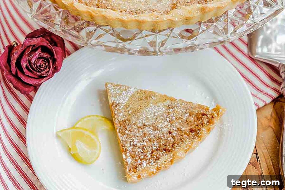 30 Gluten-Free Easter Desserts Your Guests Will Crave 21 slice of French rustic lemon tart on a plate with a slice of lemon and dusting of powdered sugar
