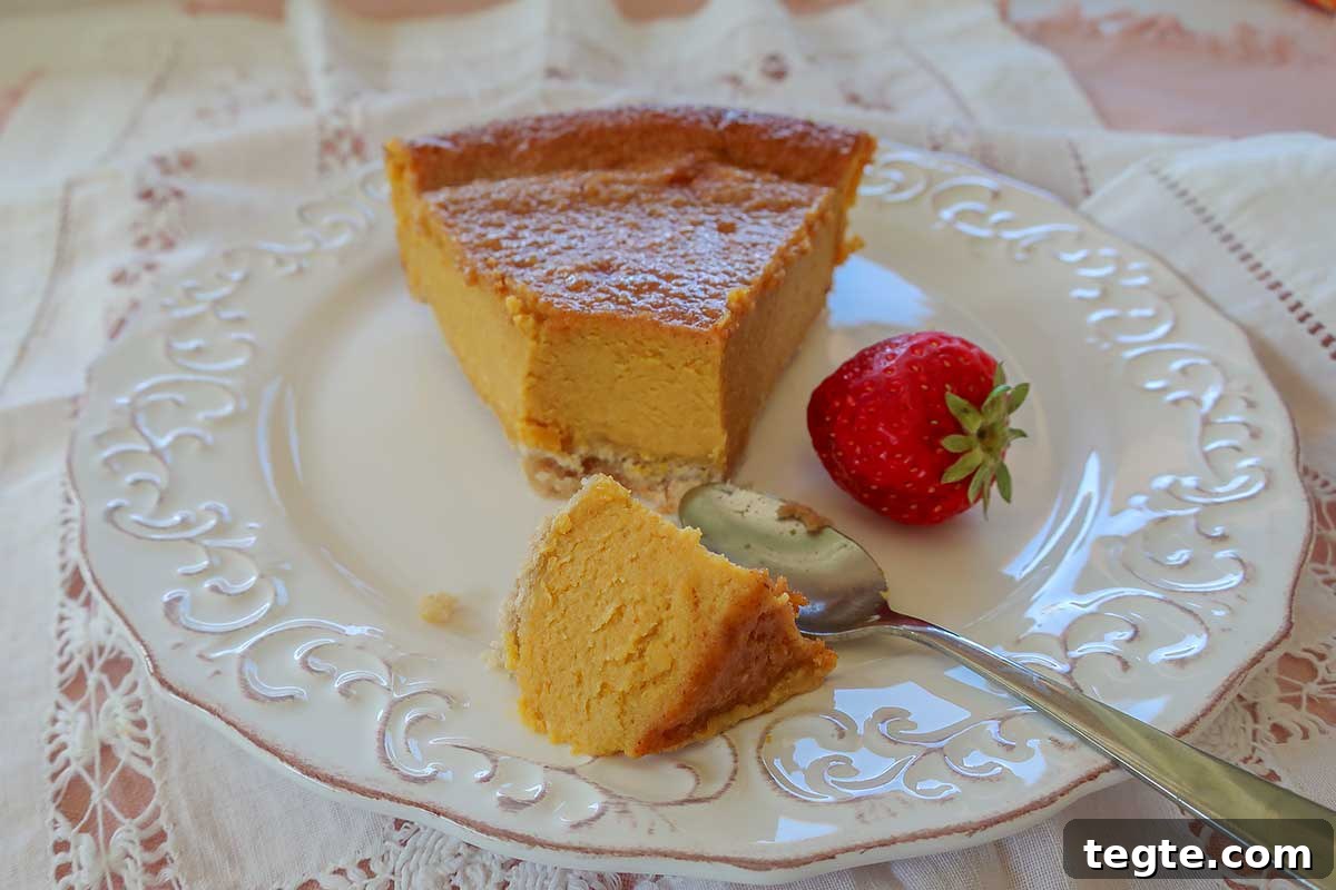 30 Gluten-Free Easter Desserts Your Guests Will Crave 5 close up of vanilla pumpkin pie slice showing creamy interior on a plate
