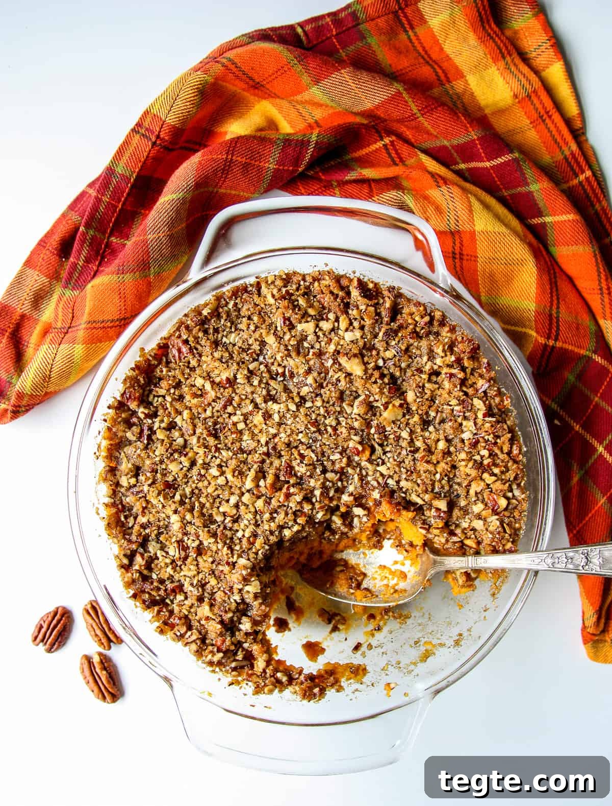 Baked sweet potato crunch casserole in a glass casserole dish.