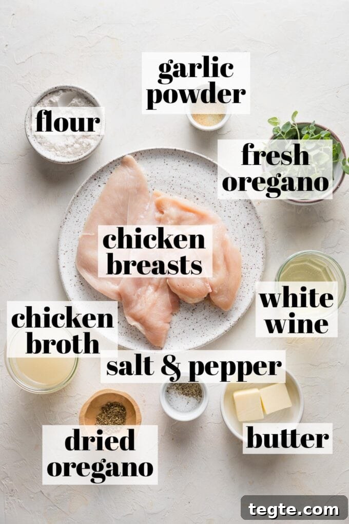 Oregano Roasted Chicken with Lemon and Garlic 3 Labeled overhead photo of chicken breasts, chicken broth, white wine, flour, garlic powder, fresh and dried oregano, butter, salt, and pepper arranged in prep bowls and on plates.