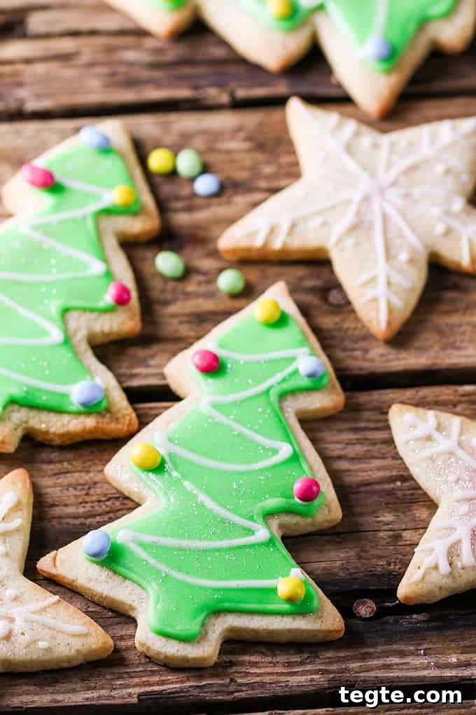 several sugar cookies with easy icing in star and tree shapes