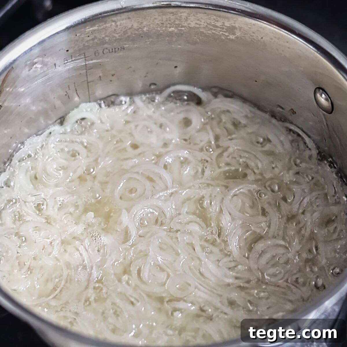 Gluten-Free Green Bean Casserole Recipe for Holiday Dinners 7 thin sliced shallots boiling in oil in saucepan.