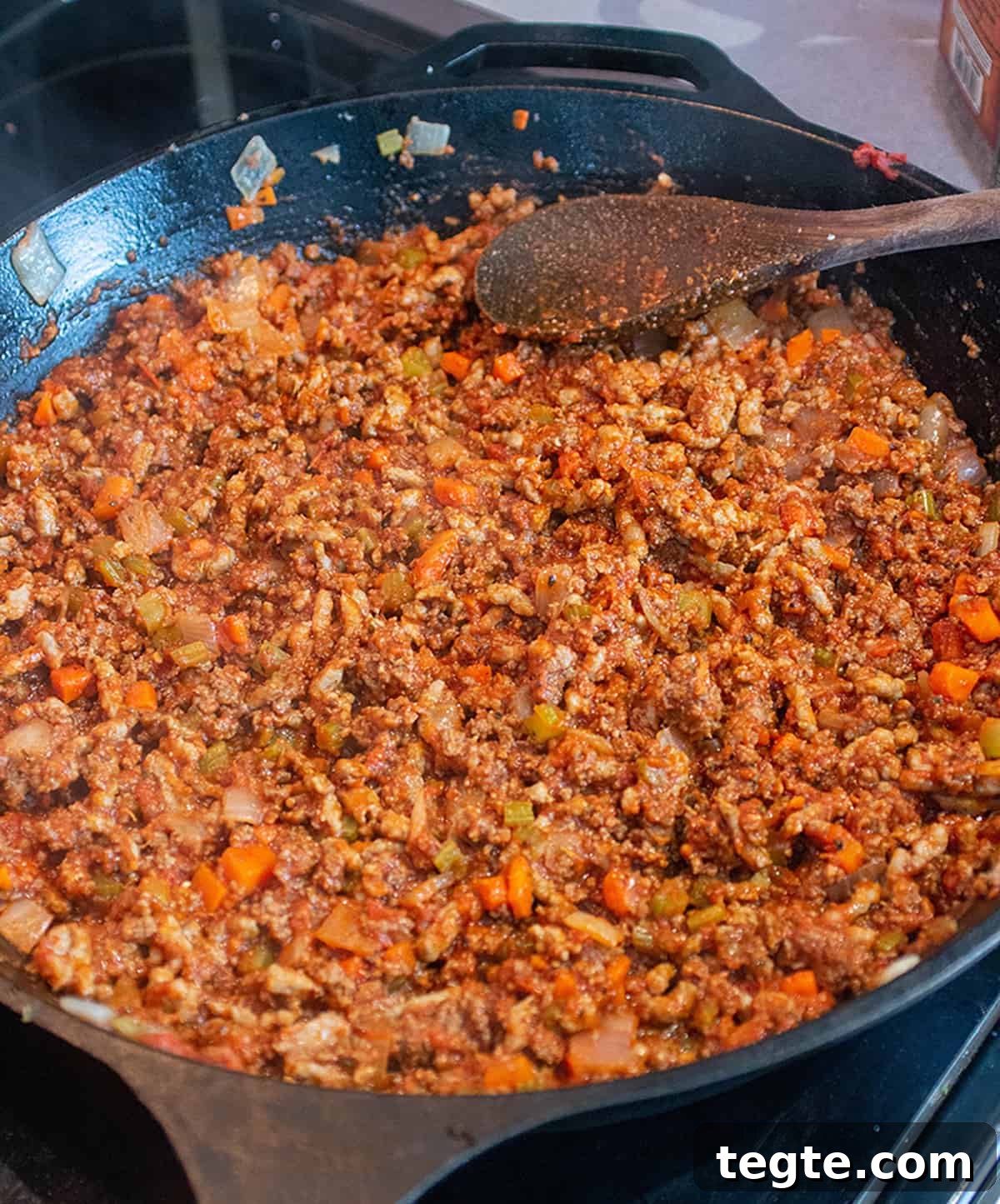 Zucchini Lasagna with Rich Bolognese Meat Sauce 4 Ground meat and sausage being cooked in a large cast iron skillet.