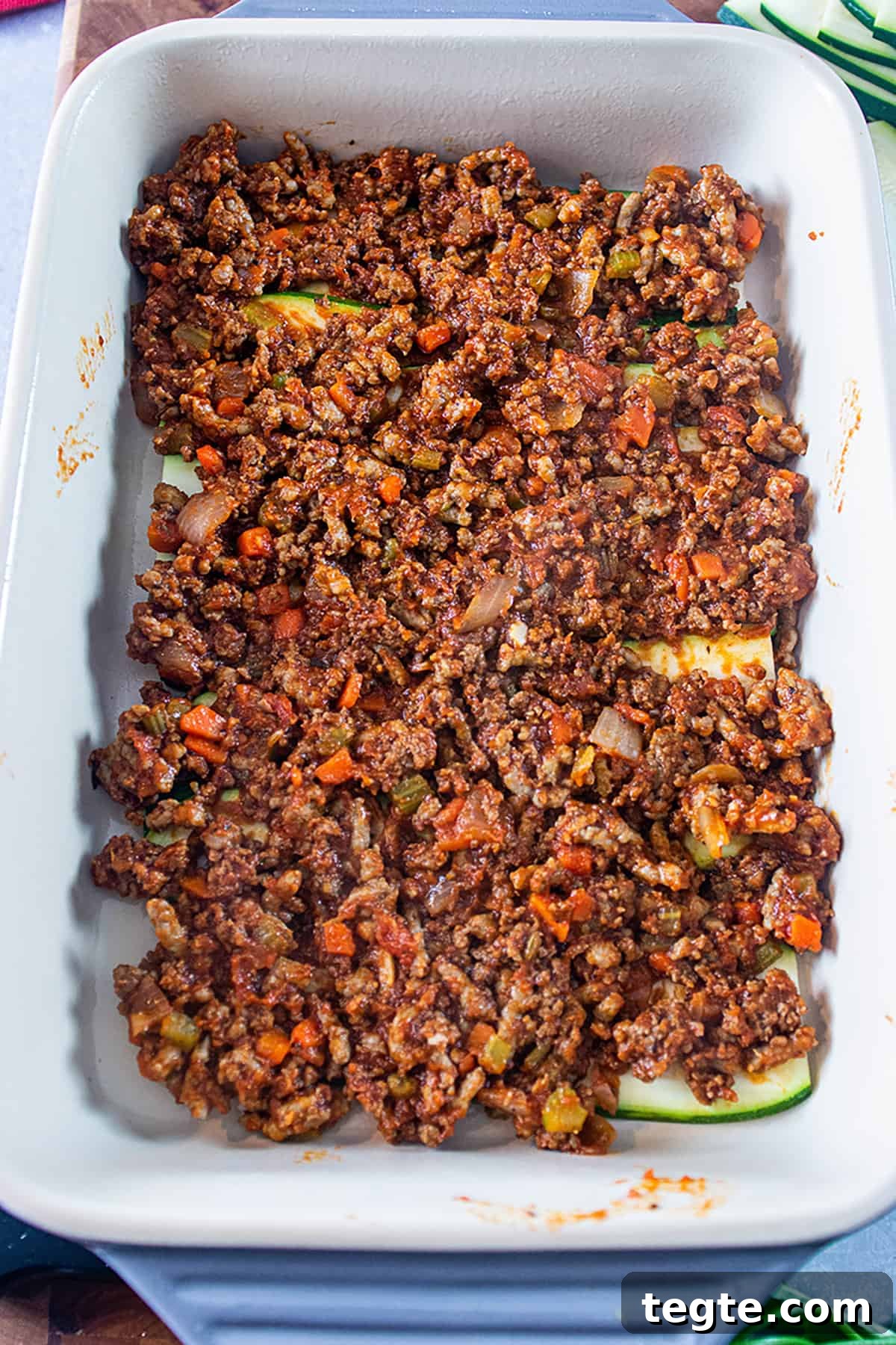 Zucchini Lasagna with Rich Bolognese Meat Sauce 6 a 9x13 dish with layers of sliced zucchini and layered ground meat.