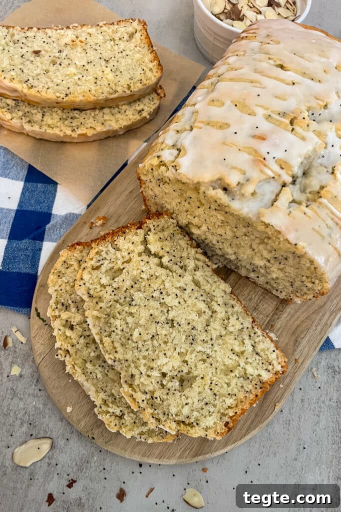 Almond Poppy Seed Quick Bread Recipe for Moist Loaves 2 almond poppyseed bread on a cutting board. Slices of bread for serving.
