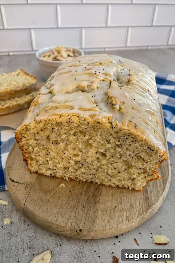 Almond Poppy Seed Quick Bread Recipe for Moist Loaves 4 loaf of almond poppyseed bread showing the inside of the bread on a cutting board