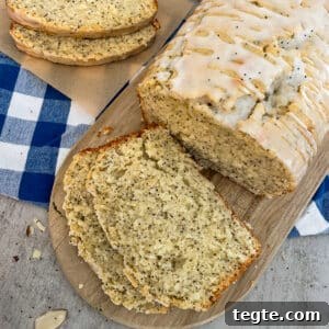Almond Poppy Seed Quick Bread Recipe for Moist Loaves 5 almond poppyseed bread on a cutting board. Slices of bread for serving.