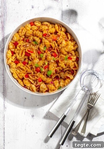 Curry noodle salad in a large white bowl.