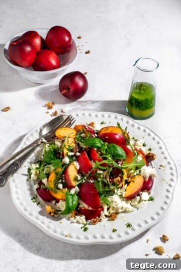 Nectarine salad on a large white plate.