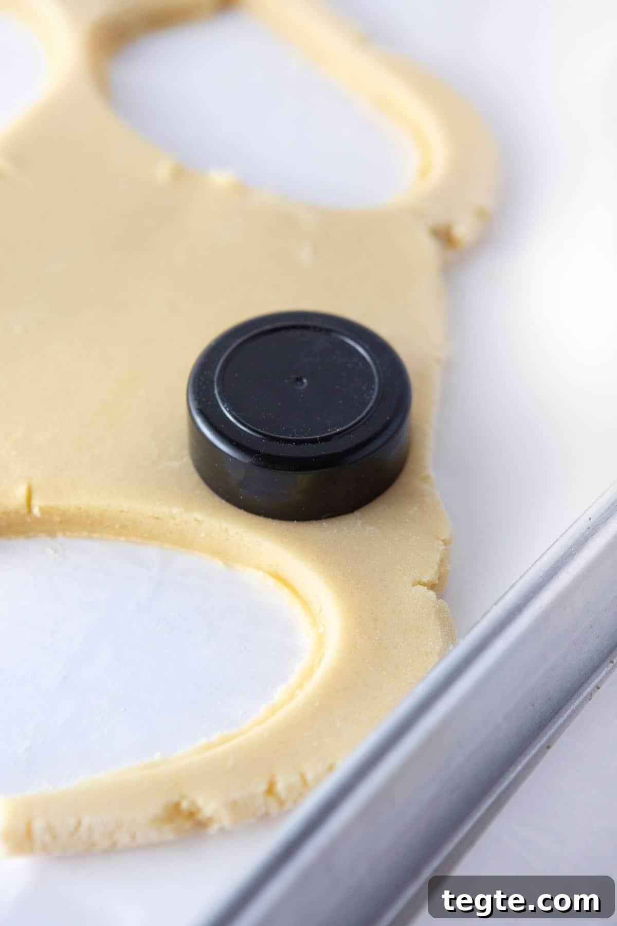 Cut sugar cookie dough with lid of spice jar