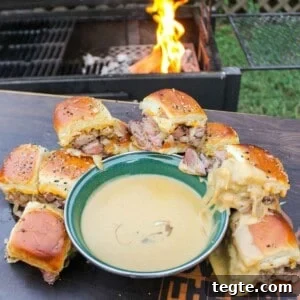 Steak Sliders with Creamy Beer Cheese Sauce 12 Steak Sliders with Beer Cheese plated next to the beer cheese ready to serve.