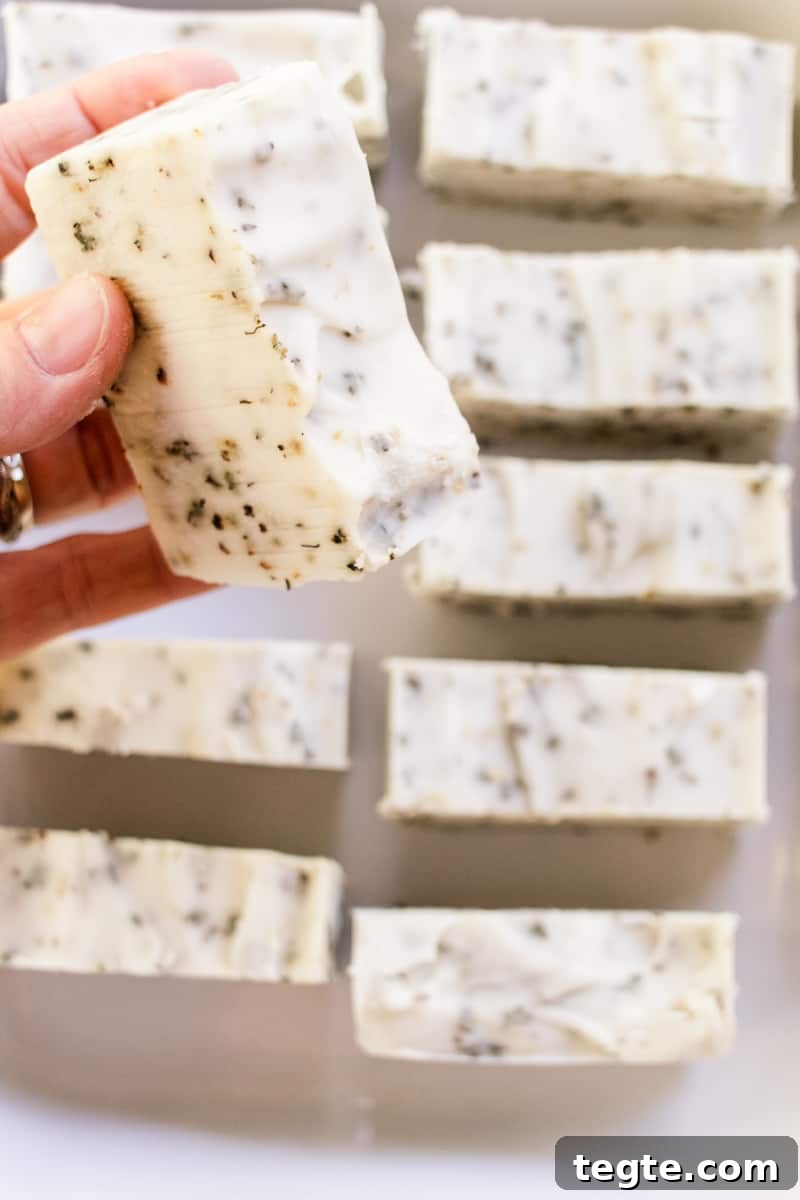 Make Herbal Soap Using Dried Herbs: Step-by-Step Guide 2 Holding up a herbal soap bar after it has fully cured.