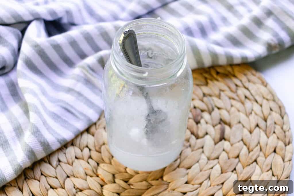 Make Herbal Soap Using Dried Herbs: Step-by-Step Guide 4 Stirring the lye into the water for the cold process soap recipe.