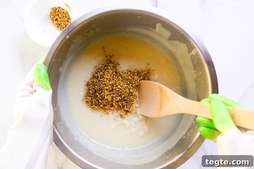 Make Herbal Soap Using Dried Herbs: Step-by-Step Guide 7 Stirring the dried flowers into the soap after it has come to a light trace.