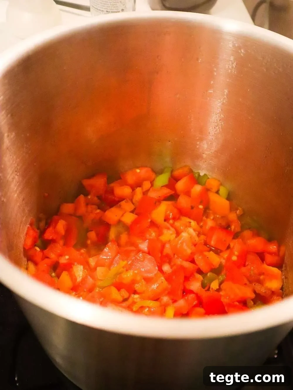 Sautéing the vegetables for the lentil chicken soup.
