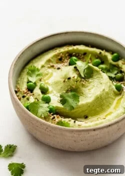 Green pea hummus in a ceramic bowl