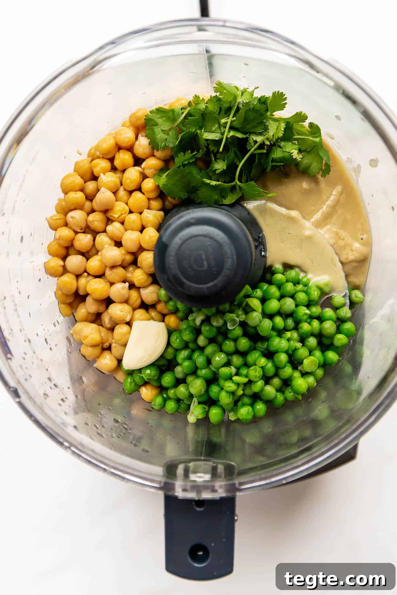 peas, chickpeas, tahini, cilantro and garlic in a food processor