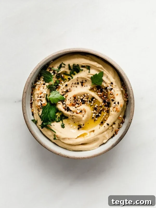 Everything bagel hummus in a small bowl topped with everything bagel spice