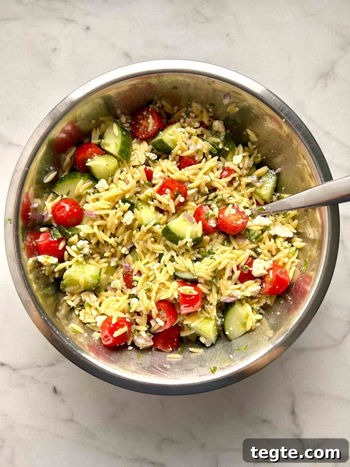 Mediterranean Orzo Salad with Lemon Herb Vinaigrette 7 orzo salad mixed in bowl.