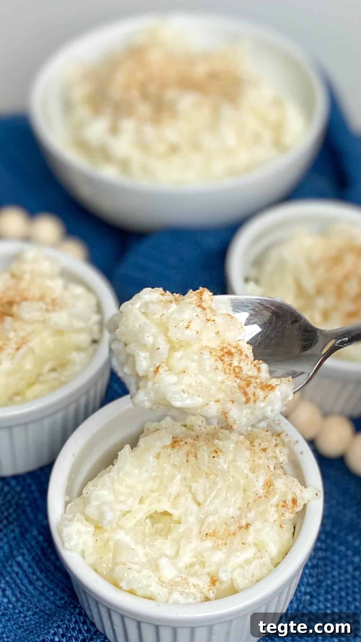 Creamy Homemade Rice Pudding Recipe with Vanilla and Cinnamon 4 Scooping out a spoonful of rice pudding.