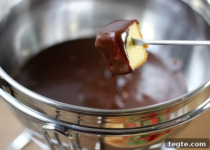 Chocolate Caramel Fondue Recipe for Dipping Fruits and Treats 9 pound cake being dipped into chocolate fondue