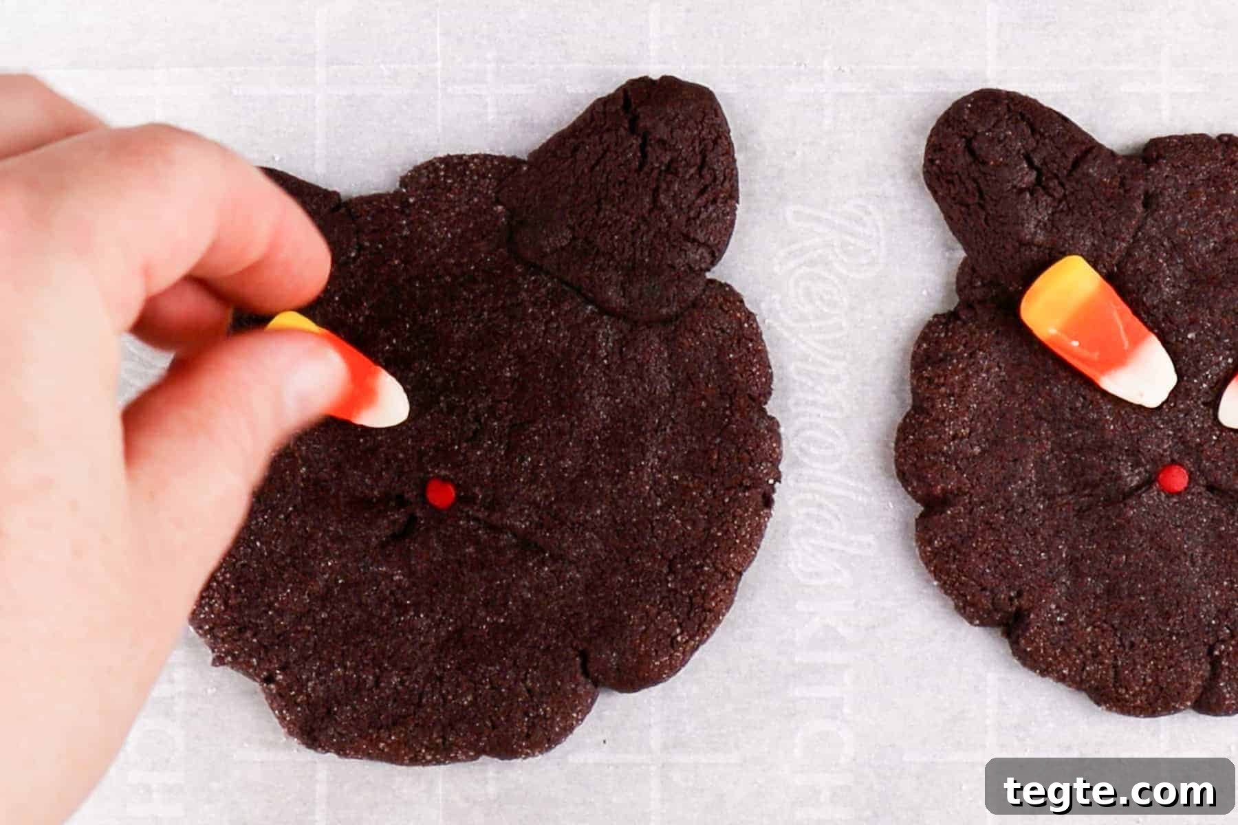 Black Cat Cookie Recipe: Soft Chocolate Drops for Halloween 12 pressing candy corn eyes onto warm cookies.