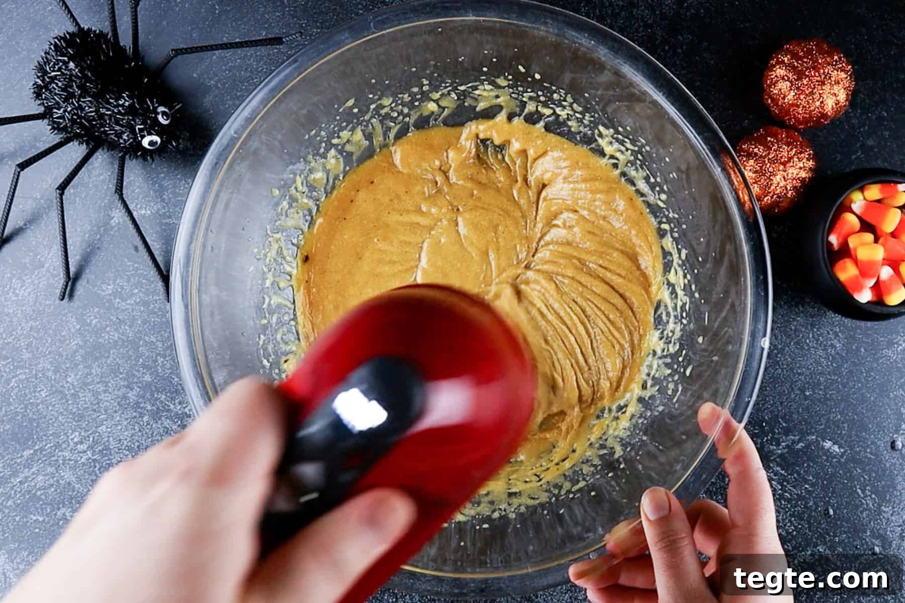 Black Cat Cookie Recipe: Soft Chocolate Drops for Halloween 6 wet ingredients mixed with hand mixer in glass bowl.