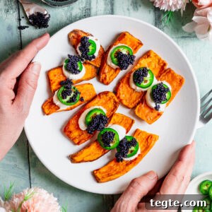 Crispy Air Fryer Sweet Potato Canapés Topped with Caviar 5 Plate of sweet potato canapes topped with sour cream, chilli pepper and caviar