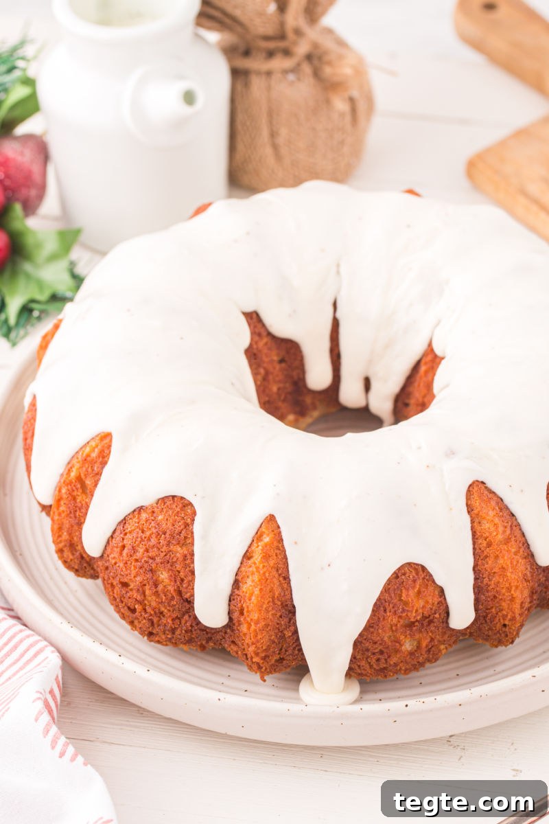 eggnog bundt cake topped with eggnog glaze on a serving plate