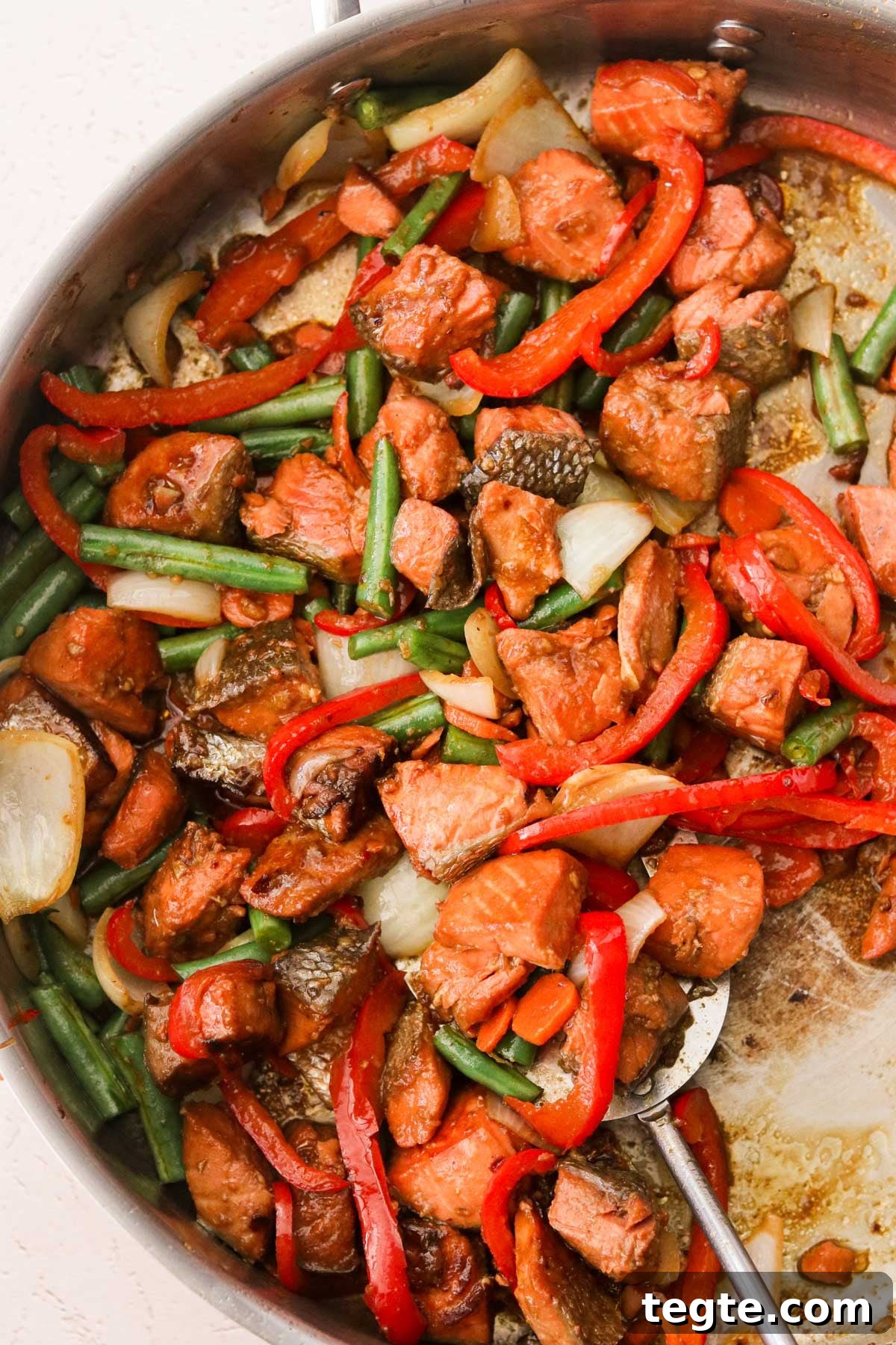 Quick Asian Salmon Stir-Fry with Garlic Soy Glaze 5 veggies and salmon cubes in a pan tossed with stir fry marinade.