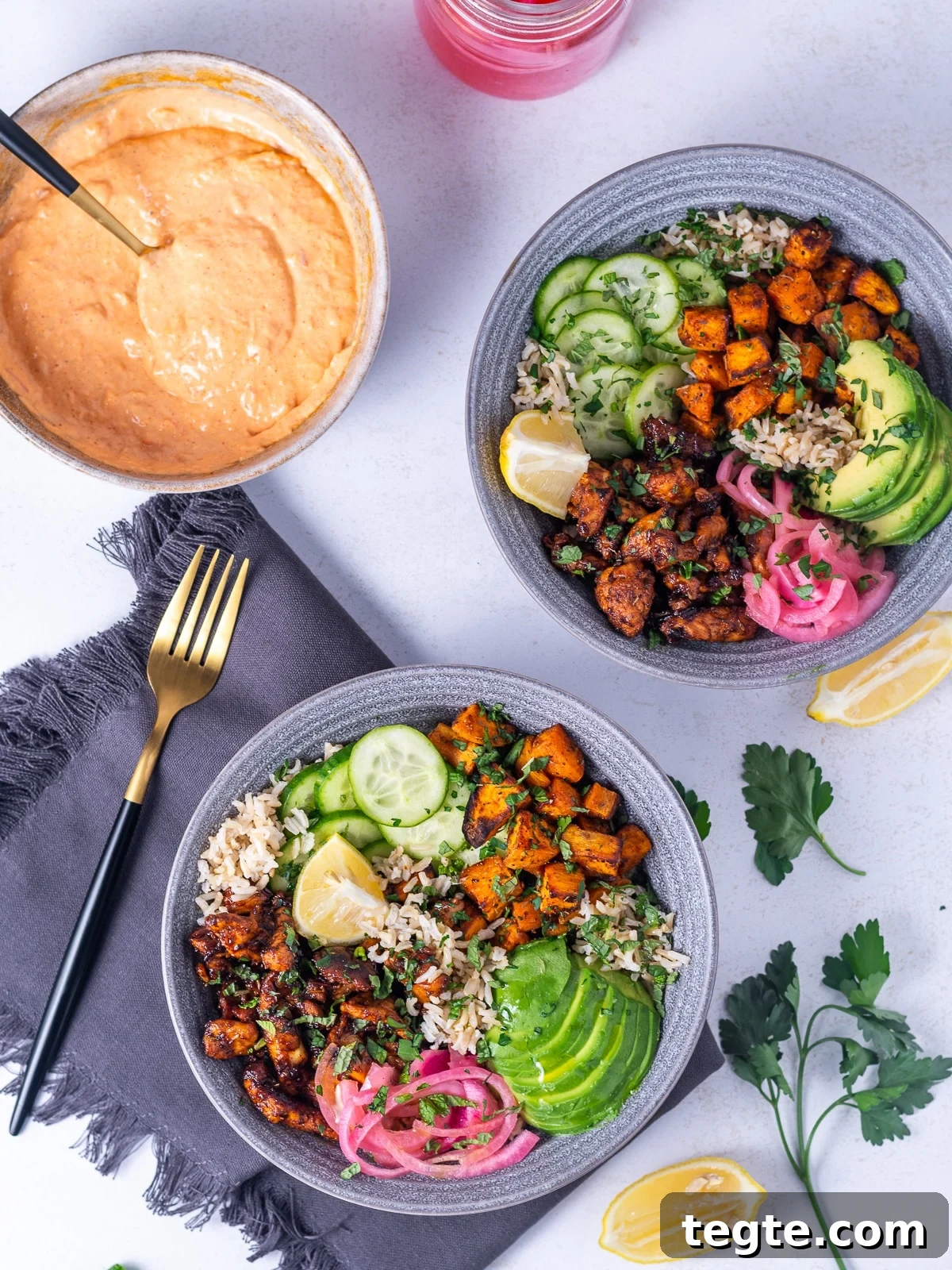 Honey Harissa Chicken Rice Bowls with Roasted Veggies 9 two honey harissa chicken bowls and one bowl of harissa aioli
