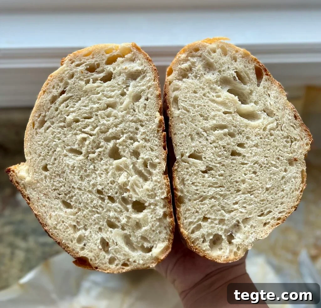 A loaf of sourdough bread has been cut in half.