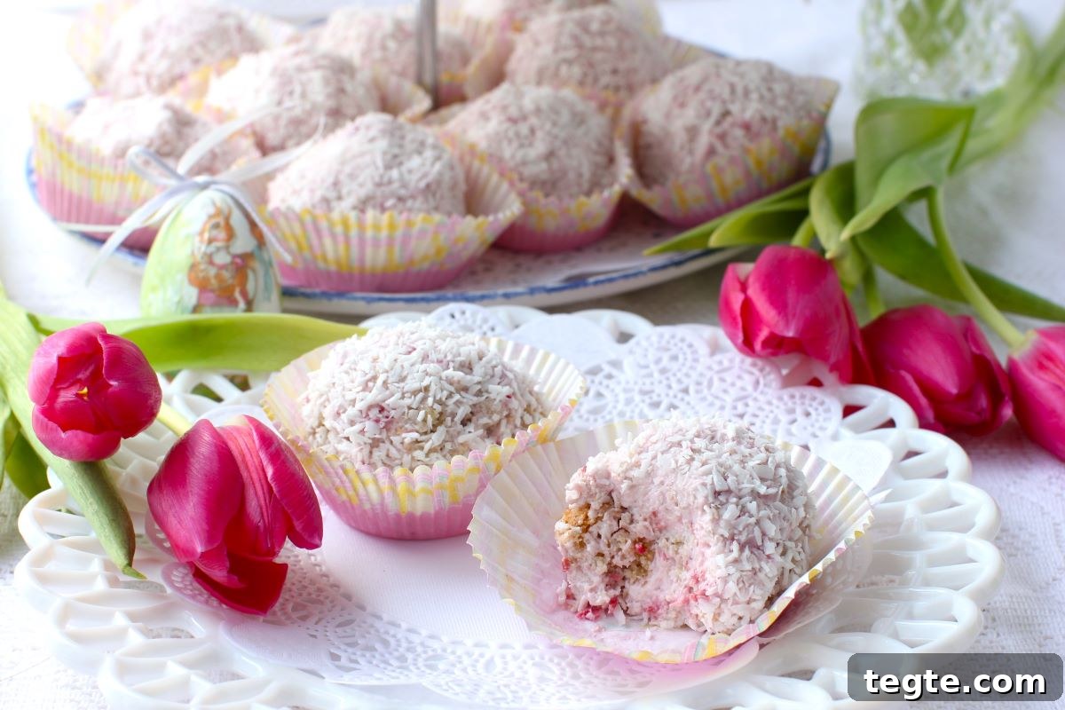 2 Raspberry Snowballs on a plate, with pink tulips laid beside.