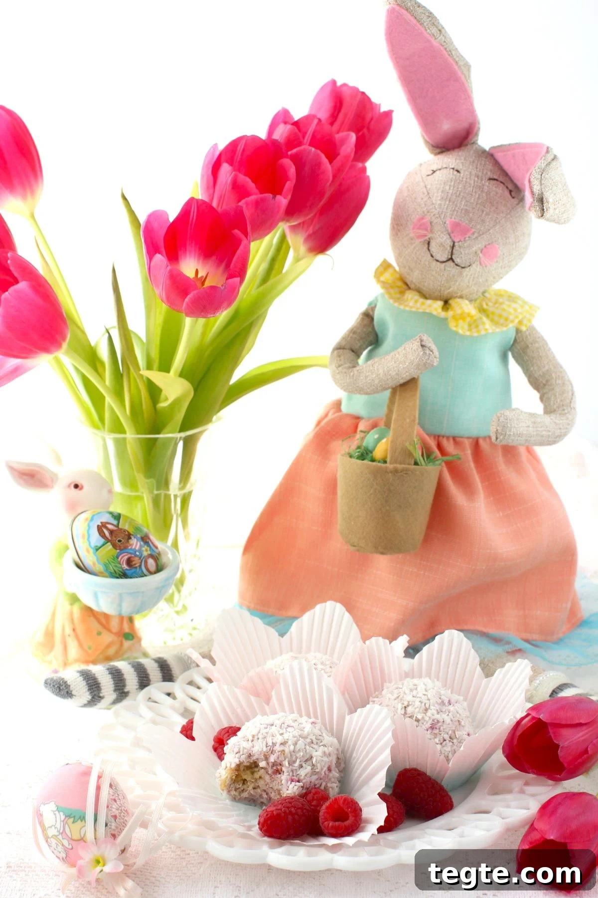 Schneeballen on a plate, with vase of tulips behind and an Easter bunny.
