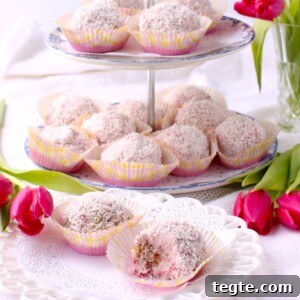 square thumbprint photo of 2-tier tray with snowballs in paper muffin cups, plate in front with 2 snowballs on it.