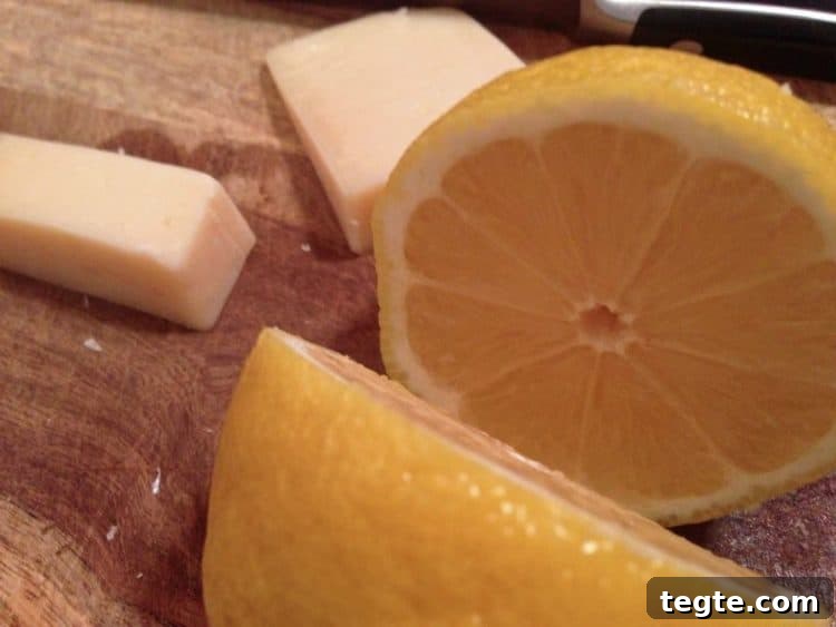 Classic Chicken Piccata with Lemon Caper Sauce 6 lemon and cheese on a cutting board