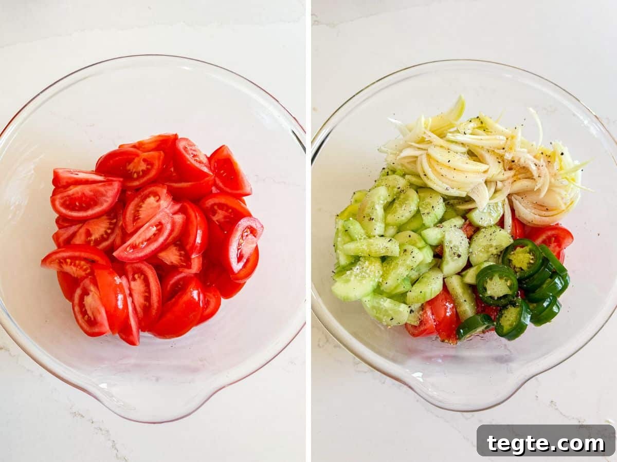Tomatoes in a glass mixing bowl and then cucumbers, onion and sliced jalapeño pepper added.