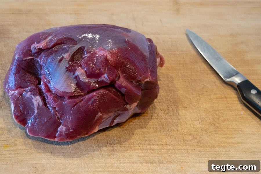 Drunken Spiced Venison Jerky Recipe 4 Venison roast on cutting board with knife