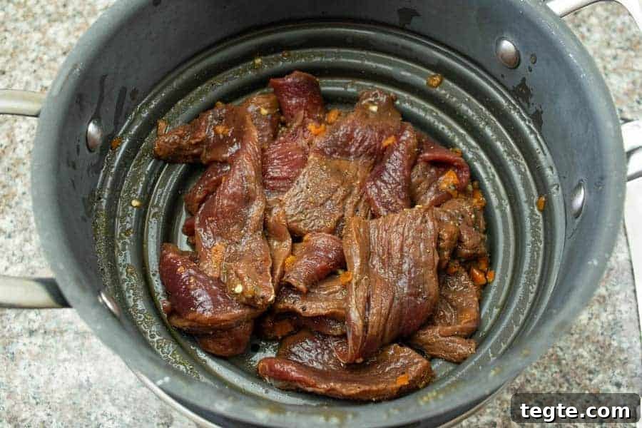 Drunken Spiced Venison Jerky Recipe 9 Habanero deer jerky straining in colander